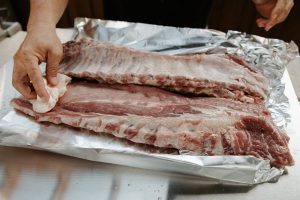 Prepare baby back pork ribs by removing the silver skin